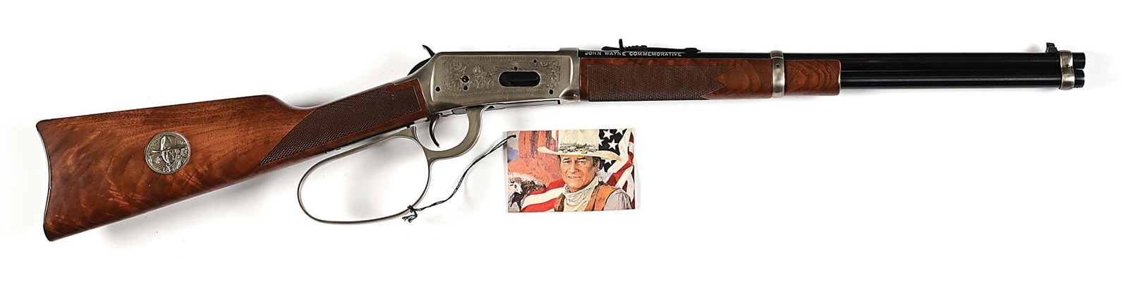 (M) JOHN WAYNE COMMEMORATIVE WINCHESTER 1894 LEVER ACTION RIFLE WITH BOX.: Manufactured circa 1981-1982. Features include blade front sight, rifle rear sight, blued barrel and magazine tube, laser engraved plated receiver, large loop, blued carbine buttplate, checkered walnu