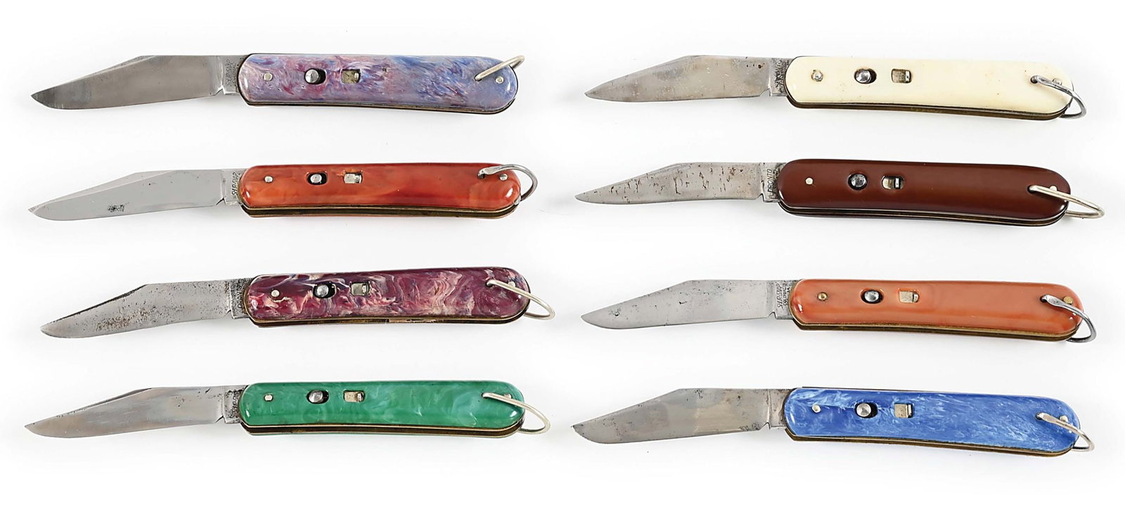 LOT OF 8: AUTOMATIC MADE BY COLONIAL KNIFE COMPANY WITH DISPLAY.: The Colonial Knife Company was formed in 1926 in Providence, Rhode Island. This is a collection of eight colorful Fatjacks. Handles are swirled or solid colorful plastic. They measure 4 1/8" closed an