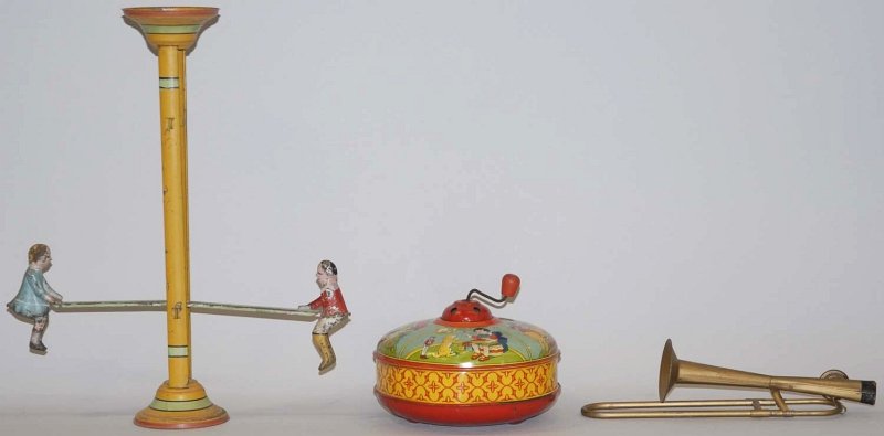 Lot of 3: Miscellaneous American Made Toys.: Includes a Gibbs hand-painted see-saw toy, a Chein lithograph top that plays music when crank is turned, and a toy trombone. Some minor paint loss and wear to Gibbs piece. Condition (Very Good). Size