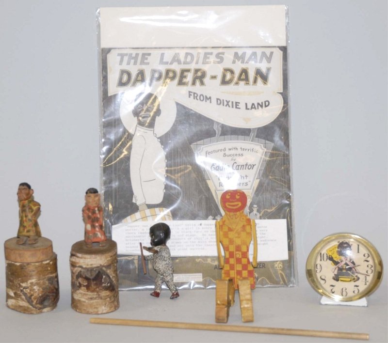 Lot of 6: African American Memorabilia Items.: Includes sheet music from Dixieland Eddie Cantor, one wooden dancing toy on stick, two wooden figures on tree stumps, one smaller figure by itself with celluloid head, and one clock that may be a cont