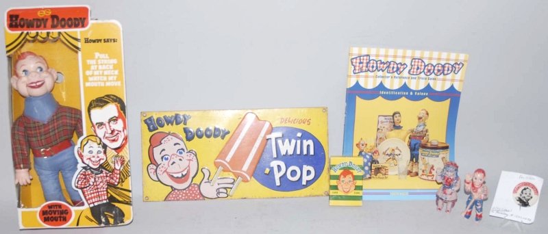 Lot of 7: Howdy Doody Items.: Includes one vintage Twin Pop Popsicle tin sign with some rust on back and edges, one doll with original box (circa 1970s), and one Howdy Doody reference guide. Also includes pin, card game and two pl