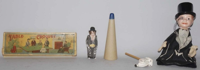 Lot of 3: Miscellaneous Character Items.: Including a Charlie McCarthy puppet marked Edgar Bergen, a small German composition bisque Charlie Chaplin figure with partial paper label on bottom and an early table croquet game in original box. So