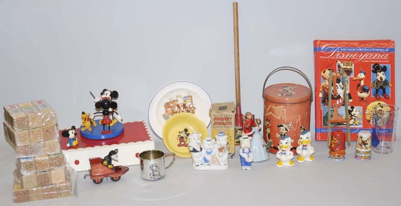 Miscellaneous Walt Disney Memorabilia & Toys.: Including a tin lunch pale, a wooden Mickey swing toy, a plastic sleeping beauty wind-up toy, block sets, glasses, a Lionel Mickey Mouse stoker train tender, Three Little Pigs bisque and other items.