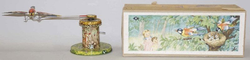 German Tin Litho Wind-Up Flapping Wing Bird Toy.: Includes original box with nice paper label. Made in western Germany. Circa 1950s. Nice bright colorful litho. Very little wear. Condition (Excellent - Near Mint). Size 14" L. 14" L.