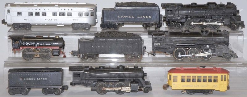 Lionel Post War Train Cars.: Includes three steam engine and tender combinations. Hillside passenger car, No. 60 Lionel Rapid Transit Trolley and steam clock-work type engine, missing wheel. Condition (Good - Very Good). Size Lar