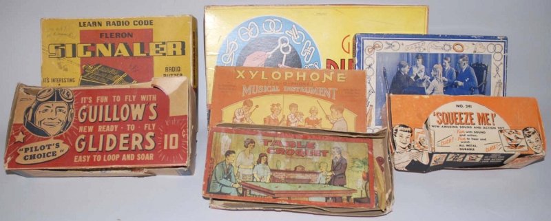 Unusual Lot of Vintage Toy Items.: Includes wooden gliders, a few tin litho squeeze toys, and a few games. All in their original boxes, some with staining. Various conditions. Condition (Very Good). Size Largest Box: 18" x 10". Largest