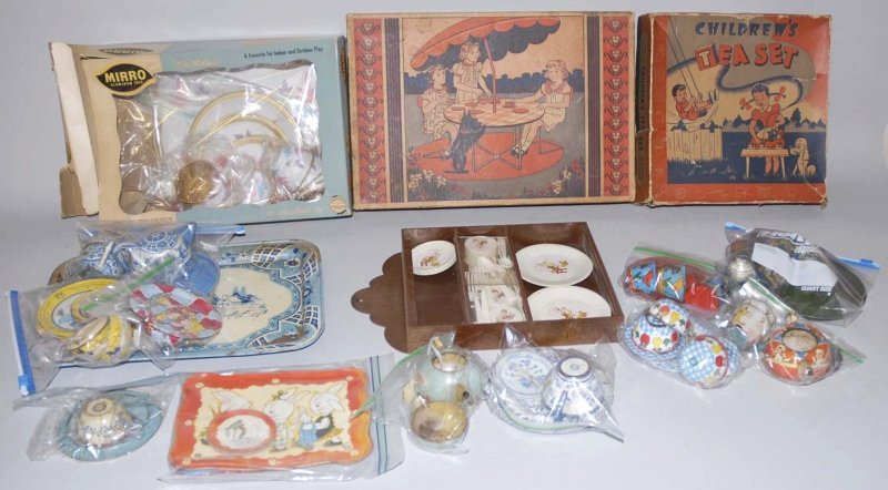 Lot of Vintage Children's Tea Sets.: Includes two by Ohio Art. Tin litho tea sets include a incomplete Pinocchio set with teapot, four plates, and three cups, a boy and girl in garden set, and a floral design set. Also includes parts fro