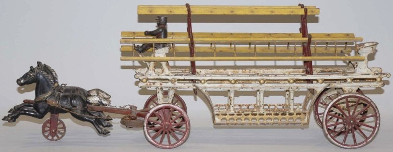 Cast Iron Horse-Drawn Fire Ladder Wagon Toy.: American. Pulled by two smaller horses. Comes with three original wooden ladders, original iron driver, and spoked wheels. Some paint loss and crazing throughout. Condition (Very Good). Size 23 - 1/2"