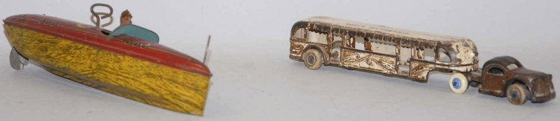 Lot of 2: American Made Cast Iron & Tin Toys.: One is a tin litho wind-up Baby L boat with driver. Probably Lindstrom. Second is a GMC Arcade Greyhound lines tractor trailer bus, with white rubber tires. One tire is replaced. Has some over-paintin