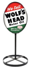 WOLF'S HEAD MOTOR OIL TIN CURB SIGN.