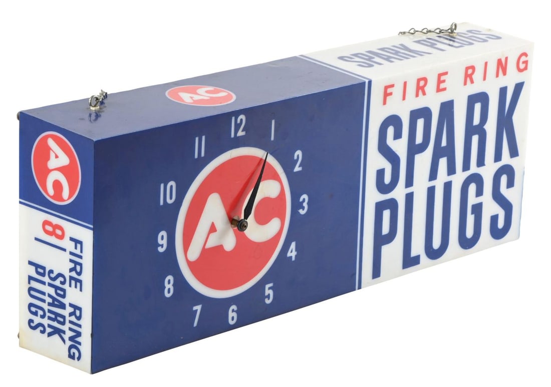 FIRE RING SPARK PLUGS LIGHT-UP CLOCK SIGN.: This C. 1960's plastic light up clock from Fire Ring Spark Plugs shows good color on the two front faces, top and side panels, as well as, the iconic AC company letters. CONDITION: The plastic body of