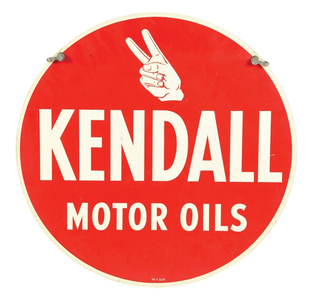 KENDALL MOTOR OIL SIGN W/ HAND GRAPHIC.: DST. Maker Marked "MCA 2288." This C. 1960's double sided tin sign from Kendall Motor Oils features nice color and shine with the famed hand graphic. CONDITION: Side 1 shows a few surface scuffs in th