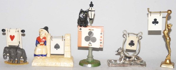 Lot of 5: Card Playing Trump Indicators.: Includes three metal, one pottery and one celluloid. Condition (Excellent). Size Largest: 5 - 1/2" T.