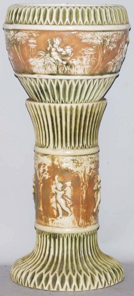Roseville Donatello Jardiniere & Pedestal.: Jardiniere with chip to rim and some crazing. Pedestal with hairline to base and some chipping to green ribs. Condition (Fair). Size 27" T.
