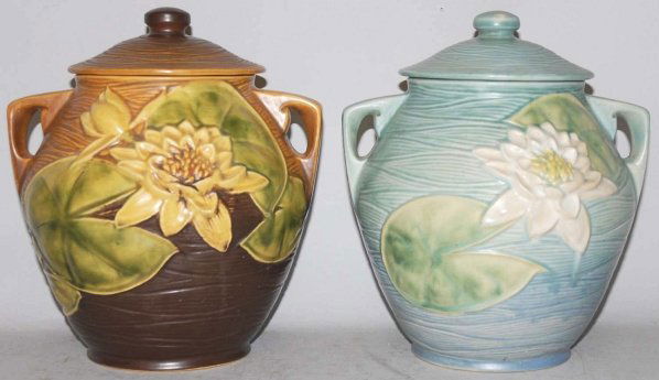 Lot of 2: Roseville Water Lily Cookie Jars.: Includes one in blue with repair to lid and repair to base of jar. Also includes one cookie jar in brown. Condition (Fair - Excellent). Size Each: 10 - 1/2" T.