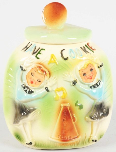 American Bisque Cheerleaders Flasher Cookie Jar.: Jar has no chips or cracks and only minor crazing. Flasher faces are still intact. Condition (Excellent). Size 10 - 1/2" T.
