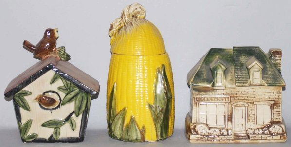 Lot of 3: McCoy Cookie Jars.: Includes the Wren House, The Cookie House and one Ear of corn cookie jar. The Wren House has moderate crazing, as does the Cookie House. Condition (Very Good). Size Largest: 12" T.