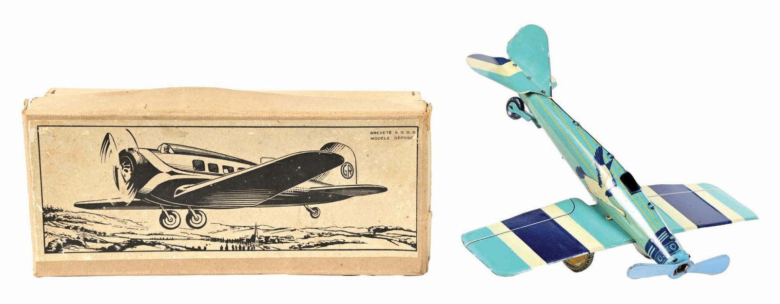 FRENCH TIN LITHO PRE-WAR AIRPLANE TOY IN ORIGINAL BOX: C. 1930s. Marked "Modele De Pose" on the box lid. It has a nice paper label and instructions on the bottom side of the lid. It has a goose on both sides of fuselage. It has the original tailfin, unusu