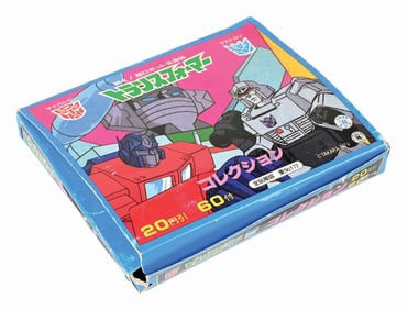 JAPANESE 1980S DECARA TRANSFORMERS STICKER BOX W/ OVER 50 PACKS OF STICKERS, SEVERAL ALBUMS & OTHER