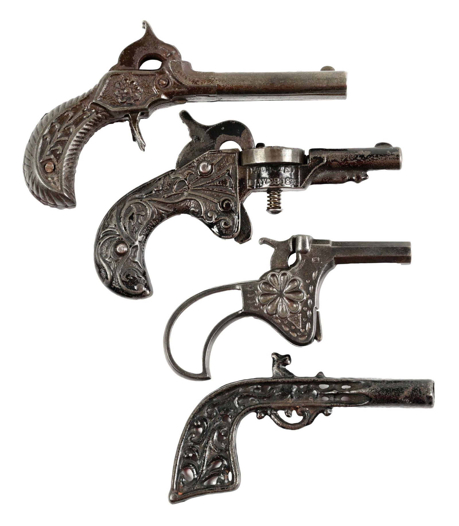 LOT OF 4: VINTAGE CAST IRON CAP GUNS: Late 19th century. An unusual one with what looks like a shotgun wheel, another single gun with a cap in the barrel, a single shot and another double shot. CONDITION: Still some Japanning remaining. C