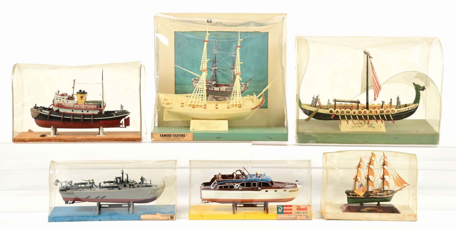 LOT OF 6: VARIOUS AURORA, REVELL & OTHER BUILT STORE DISPLAY SHIP MODELS IN ORIGINAL PLASTIC CASES: There are various ships, including WWII, pleasure ships, pirate ships and others. Factory built. Condition: (Very Good - Excellent) Dimensions: largest 12" x 5 - 1/2" x 11- 1/2"