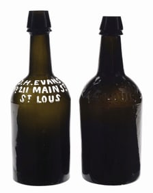 PAIR OF D. H. EVANS EMBOSSED RAISED LETTER BEER BOTTLES