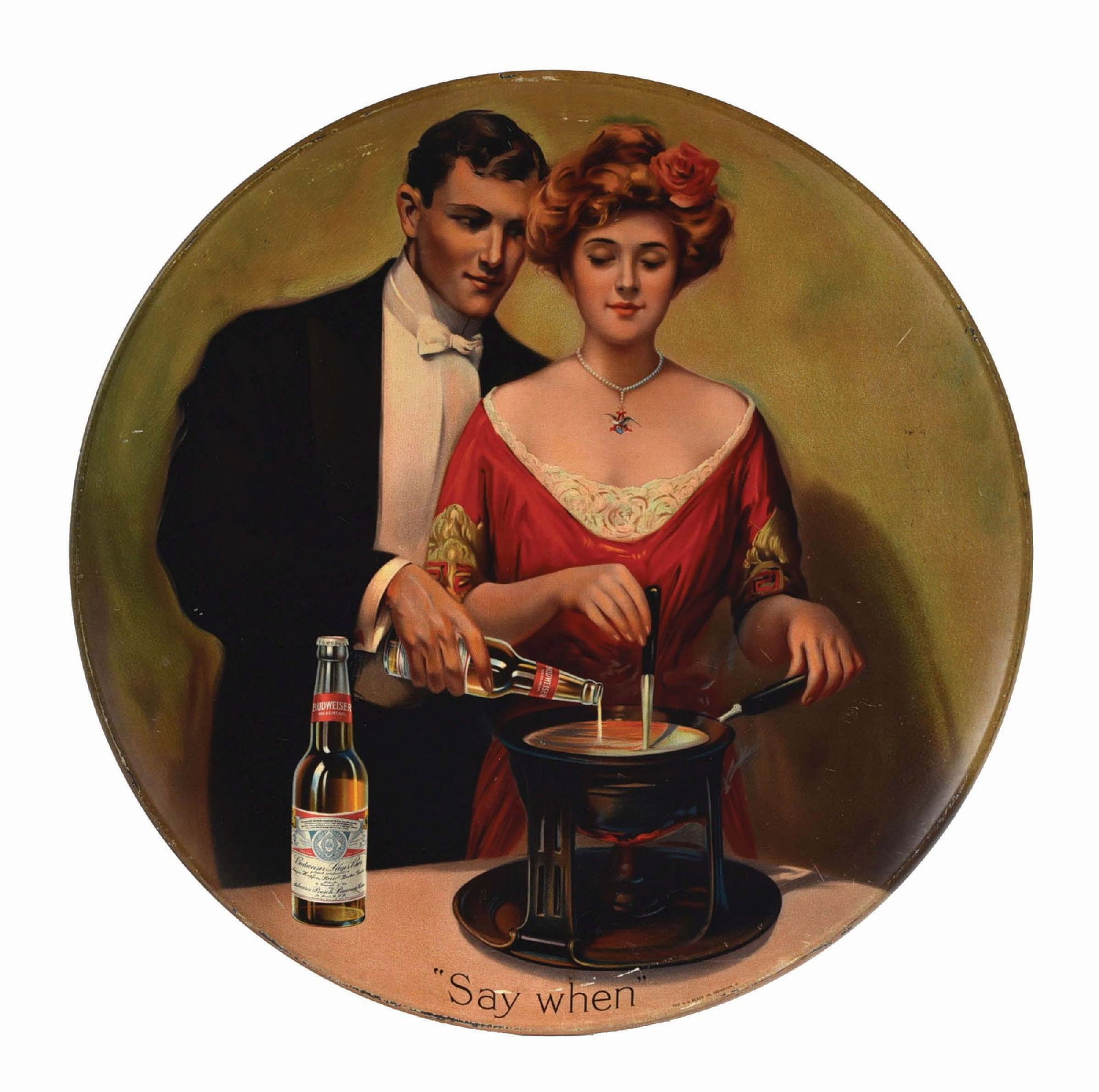 ANHEUSER-BUSCH BUDWEISER "SAY WHEN" CHARGER: An early sensual scene of a man in tuxedo pouring beer into the fondue pot. Manufactured by the HD Beach Company. CONDITION: It has a clean face. There is some scratching, mostly to the outer edge. Co