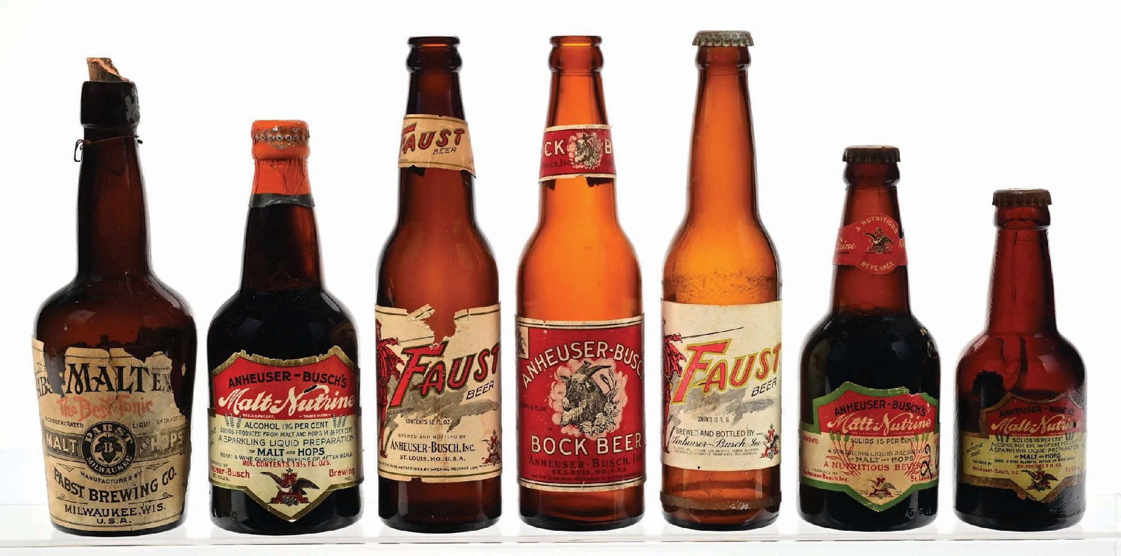 LOT OF 7: ANHEUSER-BUSCH & PABST LABELED BOTTLES: All the bottles show some general wear, tearing and loss. They all display well. Condition: (6). Dimensions: Largest: 9 - 1/2" T.