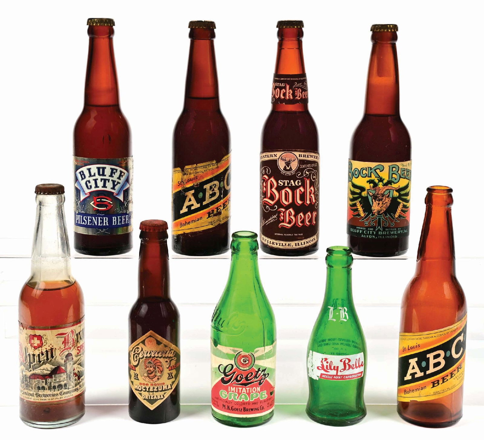 LOT OF 9: LABELED & PAINTED LABELED BOTTLES: All labels have some wear. There are several with original crowns. Condition: (5.0 - 7.0) Dimensions: Largest: 2 - 1/4" x 2 - 1/4" x 9 - 1/2".