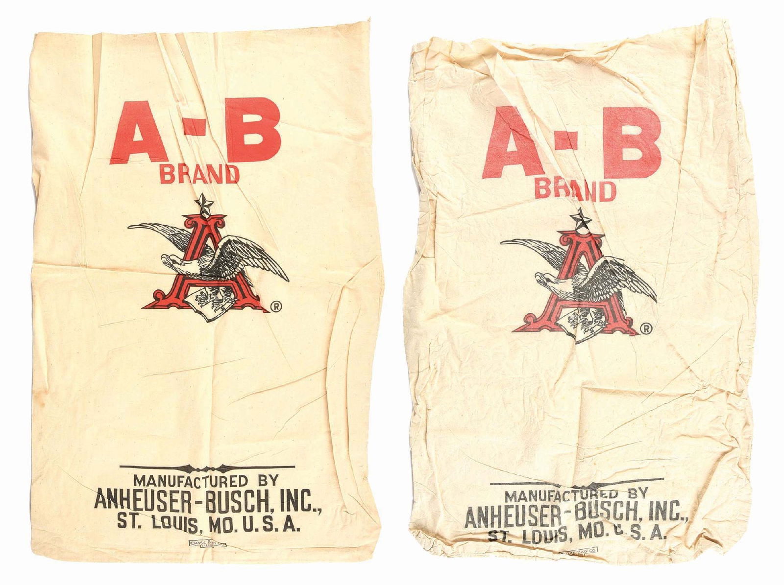 PAIR OF ANHEUSER-BUSCH FLOUR CANVAS BAGS: C. 1930s - 1940s. Manufactured by Chase Bag Co., St. Louis. CONDITION: One bag is clean with minor wear, the other has some staining and wrinkles throughout. Condition: (6.0 - 7.0) Dimensions: 38" x 2