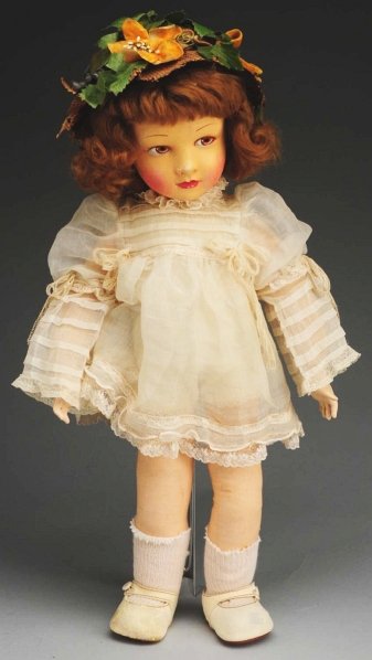 Lovely French Cloth Child Doll.: Probably by Raynal, all cloth with beautiful face featuring hand-painted eyes and mouth, rosy cheeks, curly mohair wig; jointed shoulders and hips with celluloid hands; organdy dress, straw hat with f