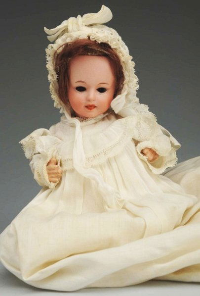 Saucy German Bisque Character Doll.: Socket head with square mark of Gebruder Heubach (firing crack on rim, light speckling) mold 8550, cute face with sleeping eyes and molded tongue sticking out, replaced mohair wig; five piece baby bod