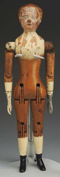 Joel Ellis Wood Doll.: American, 1873. All wood with carved hair (paint worn as usual with repair and touchup), fully jointed with metal lower arms and legs (possible repaint to legs). Condition (Good). Size 12" T.