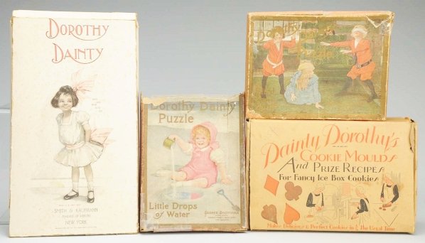 Lot of 4: “Dainty Dorothy/Dorothy Dainty” Items.: “Dainty Dorothy’s Cookie Moulds and Prize Recipes for Fancy Ice Box Cookies” in original box (some wear on box); “Dorothy Dainty” boxed puzzles by Parker Bros. Little Drops of Water (box det
