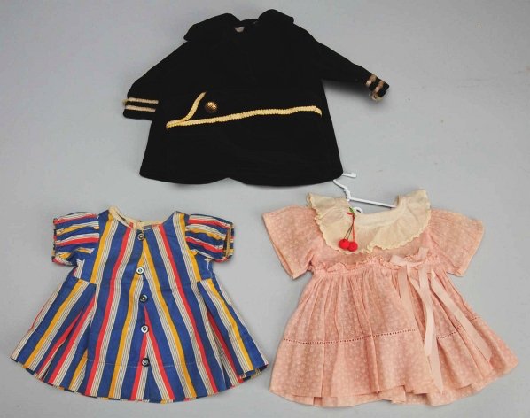 Lot of 3: Original “Shirley Temple” Dresses.: Tagged black velvet coat and hat American Legion outfit; tagged striped blue/pink/yellow dress from “Curly Top,” untagged pink print dress with cherries (yellowed collar). Condition (Very Good).