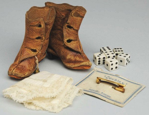 Lot of French Fashion Doll Accessories.: Antique light brown fashion boots, 2” long, with heels (each missing 2 buttons, some wear, but no breaks), lace-trimmed handkerchief, Bébé pin on original card. Small dice in new box. Condition (G