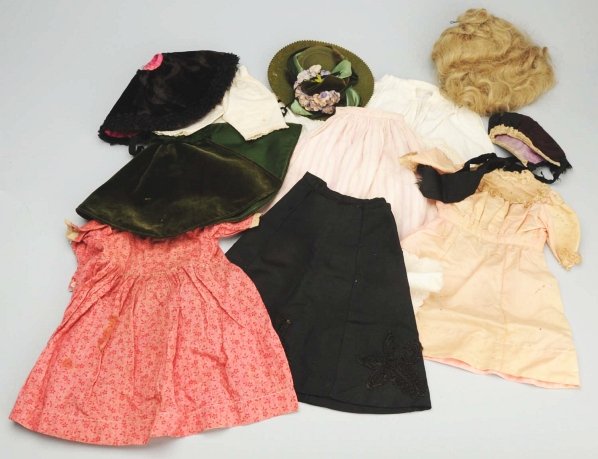 Lot of Antique Doll Clothing.: Red print cotton dress, black fashion skirt and cape, brown bonnet, 2 white dresses, pink silk dress (age holes), embroidered bib; 5 pieces underwear; newer green felt hat and matching green velvet ca