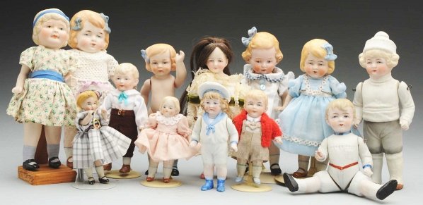 Lot of 13: All-Bisque Dolls.: Most are German. 3 boys with molded clothes and jointed shoulders (boy in white sweater with leg repaired); 4 girls with molded blue hair bows (l with replaced arms and legs, 1 reproduction, 1 with Li