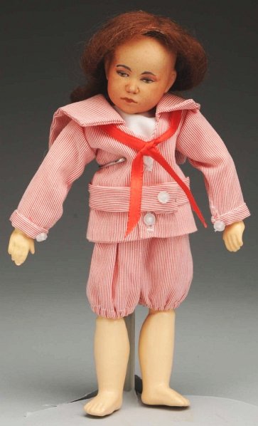 Unusual Bisque Character Doll.: Tinted light brown socket head (some speckling) incised “D F B” in script made by DeFuisseaux in Baudour Belgium, with black tapered eyebrows, brown painted eyes with shaded upper eyelids, pink ey