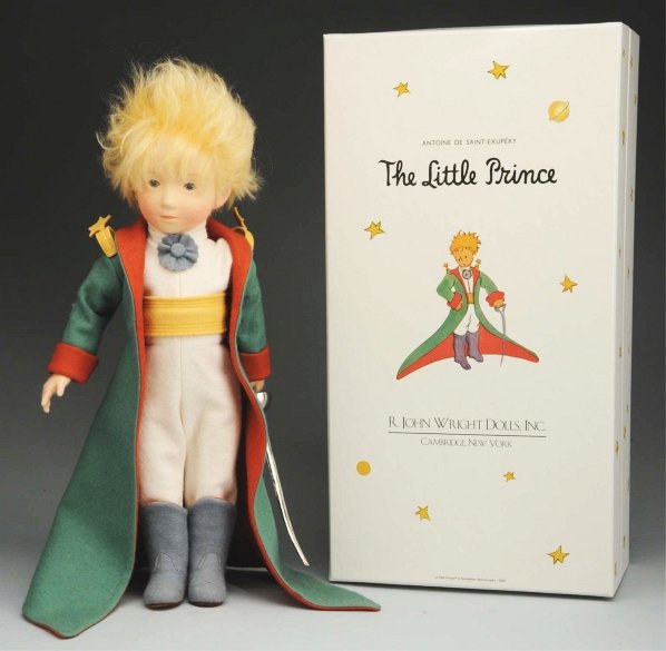 R. John Wright “The Little Prince” Doll.: All-felt doll with molded features and mohair wig in original clothing with certificate #361 of 1,000. Original labeled box. Condition (Excellent). Size 15" T.