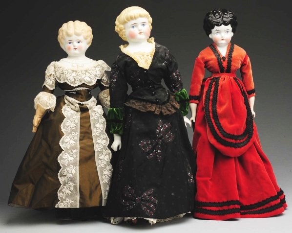 Lot of 3: German Porcelain Head Dolls.: Alt, Beck & Gottschalck blonde “Highland Mary” incised “1000 #9” with newer cloth body with replaced china limbs, redressed. Parian with molded shoulder plate with wavy short hair painted feat