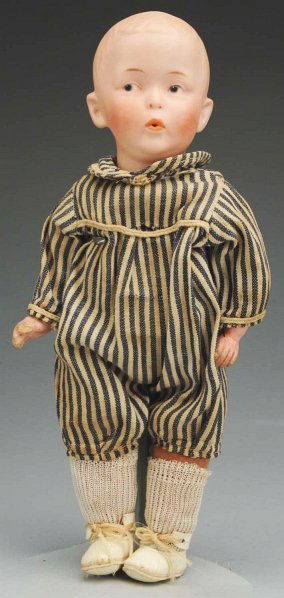 Heubach “Whistling Jim” Character Doll.: German bisque socket head incised with square mark of Gebruder Heubach, mold 8774, intaglio eyes, open mouth pursed to whistle, original cloth body with whistling bellows and composition lower arms (w
