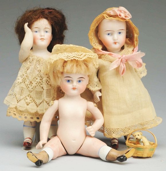 Lot of 3: German All-Bisque Dolls.: Kestner with painted features, no wig, original clothes; Kestner character girl with dimples and 2 painted teeth; Alt, Beck & Gottschalck girl with painted features, mohair wig, pegged shoulders and h