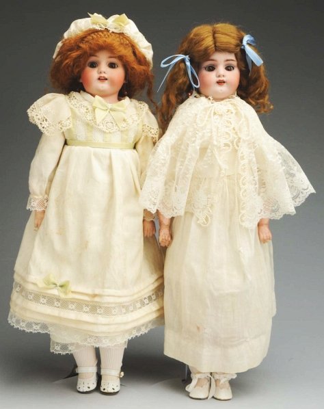 Lot of 2: Simon & Halbig “Dainty Dorothy” Dolls.: Bisque shoulder heads incised “Germany Simon & Halbig 1080” with replaced eyes, open mouth with upper teeth, pierced ears, replaced mohair wigs; white kid bodies with rivet-jointed hips, knees and
