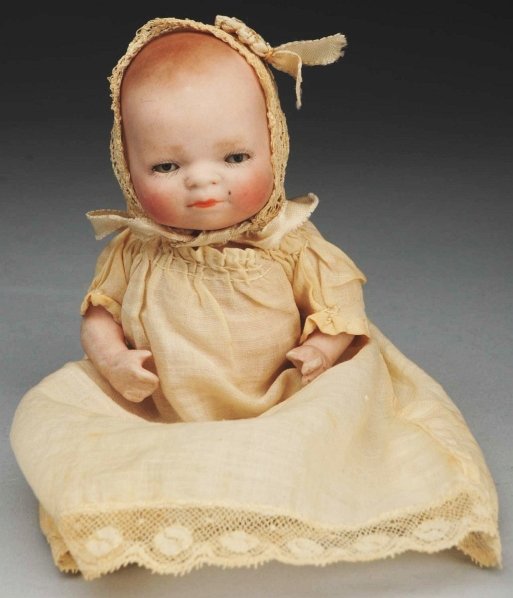 Sweet All-Bisque “Bye-Lo Baby” Doll.: Incised “6-12 Copr. by Grace S. Putnam Germany.” Molded hair, sleeping eyes, swivel neck, jointed shoulders and hips, all original body parts (black speck on cheek). Dress and hat may be original.