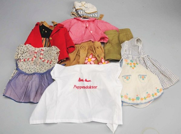 Lot of Clothing Appropriate for Kathe Kruse Dolls: Vintage cotton and velvet dress, red felt coat (hole in back), short green cotton pants, embroidered hat, Kruse “Puppendoktor” coat, white gauze dress, 2 aprons, 2 print dresses, new tagged Kruse 