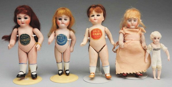 Lot of 4: German All-Bisque Dolls.: Three with glass eyes and mohair wigs, jointed shoulders and hips with torso labels: “Our Mary” by Limbach, “Prize Baby” by Hertel, Schwab & Co. and “Princess” by Alt, Beck & Gottschalck. 