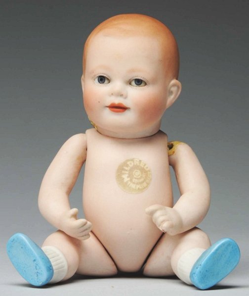 Rare “Mildred the Prize Baby” All-Bisque Doll.: Fully incised “Copr. By Mildred The Prize Baby Germany 880-15” and with paper sticker on tummy. Painted and molded hair, brown sleeping eyes (flake on lower right eye), closed mouth; swivel neck, 