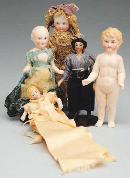 Lot of 5: Bisque Dolls.: Rare all-bisque man with molded hat and side burns, swivel neck, jointed shoulders and hips, molded boots, original clothing; early all-bisque girl with gold luster boots (dress deteriorating); bathin