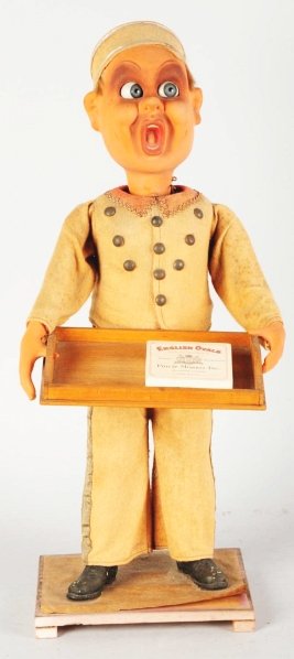 Amazing Clockwork Window Display Bell Boy.: 1930s. This guy has a fantastic character face. His head moves side-to-side and so do his big eyes. Holds a wooden tray that may have had cigarettes or candy originally. All original composition figur
